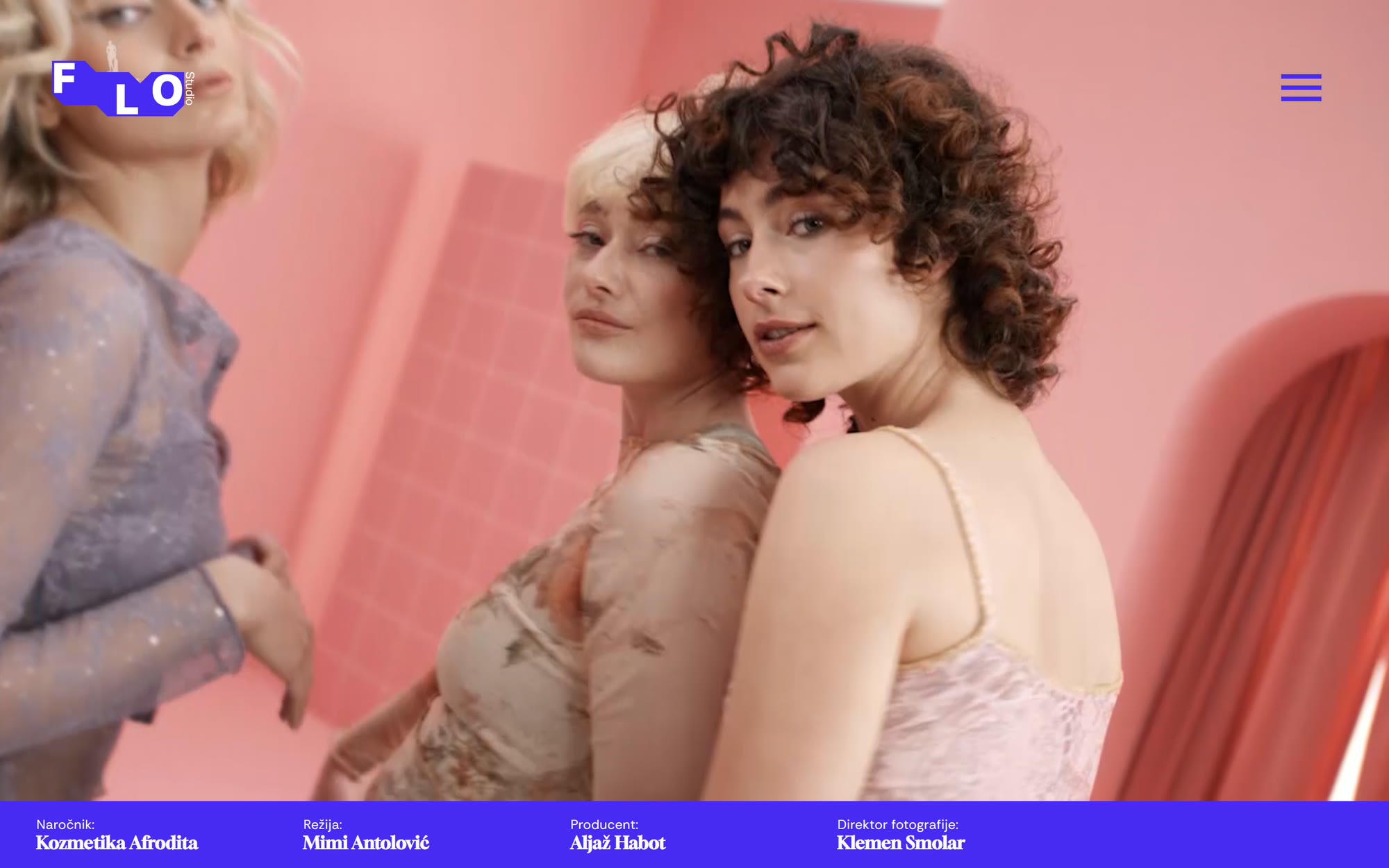 The FLO Studio home page: a full-screen still from a cosmetics film, the FLO mark at the top left and a violet credit bar along the bottom.